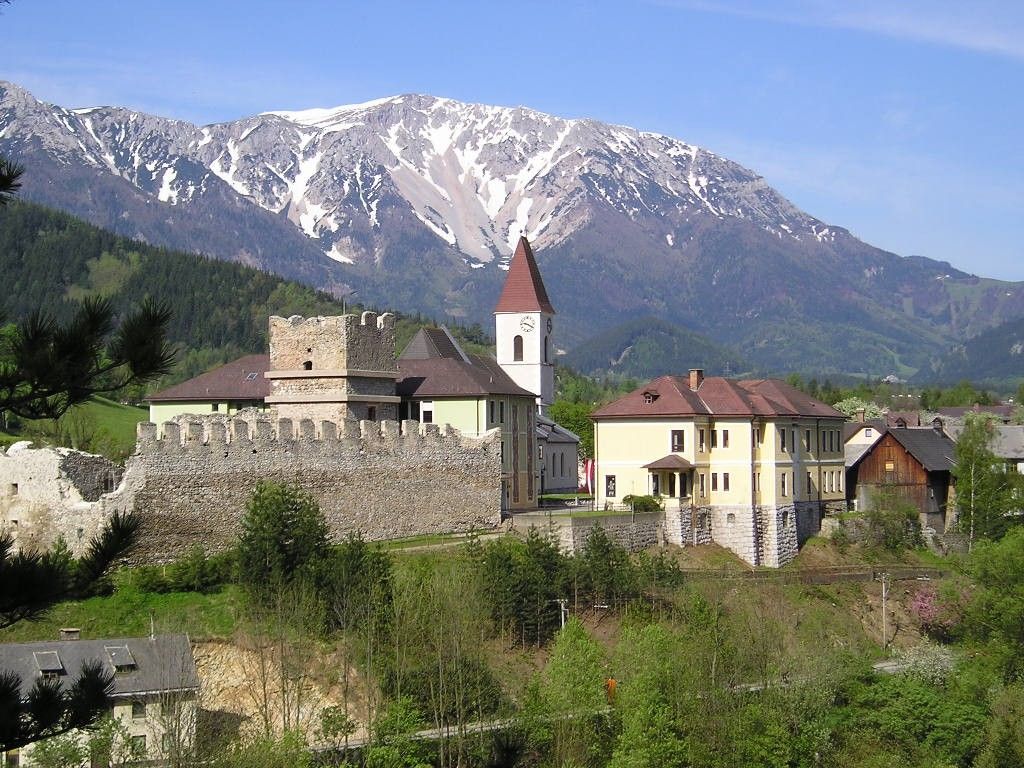 Puchberg castle ruins with snow-covered mountain in the background.