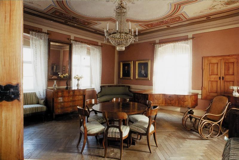 Elegant living room in the Hugo Wolf house with antique furniture and chandelier.