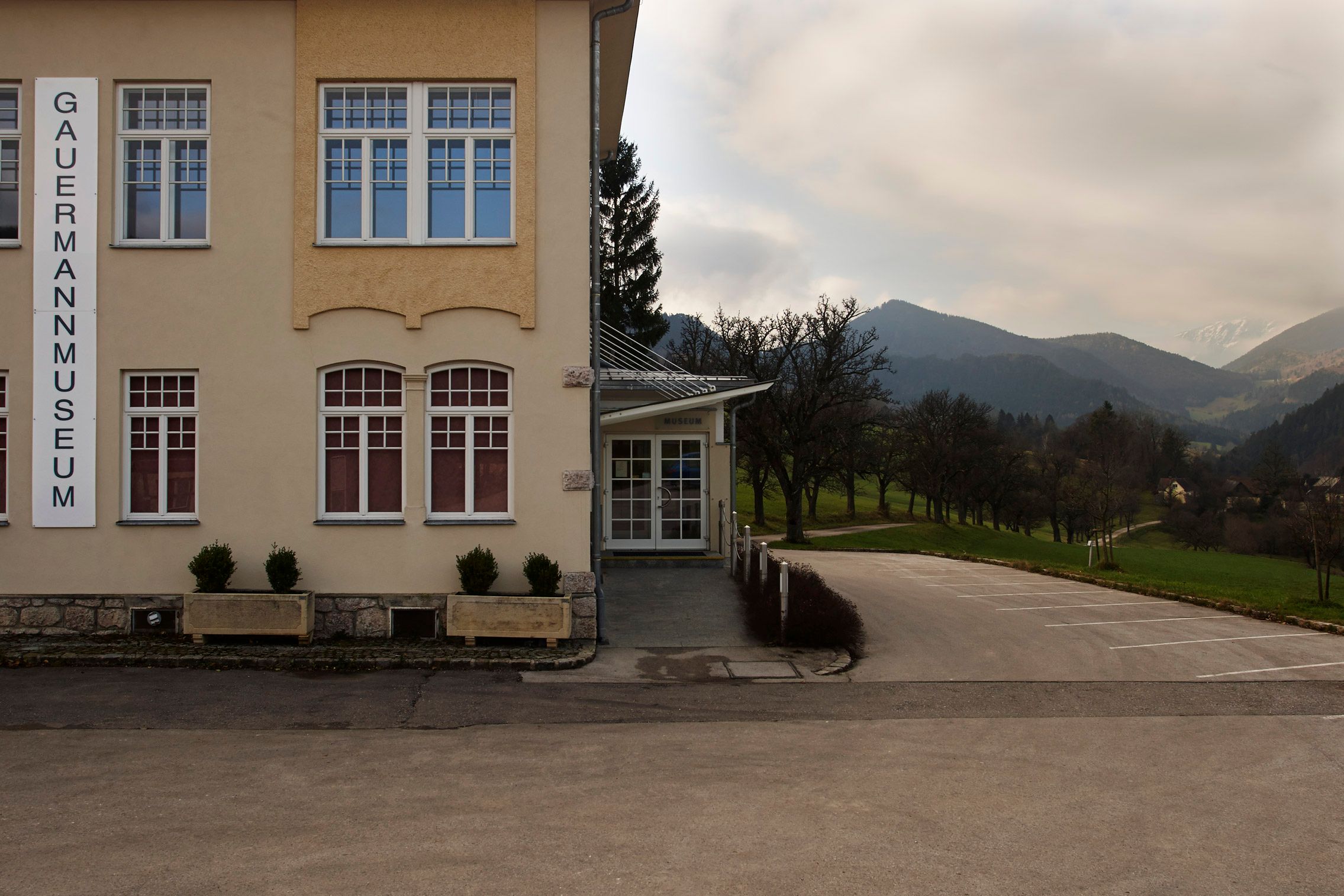 Exterior view of the Gauermann Museum in Miesenbach with mountain landscape in the background.