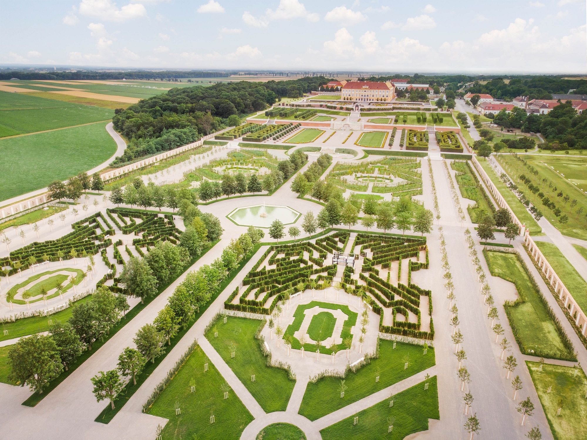 Aerial view of Schloss Hof with symmetrical gardens and paths.