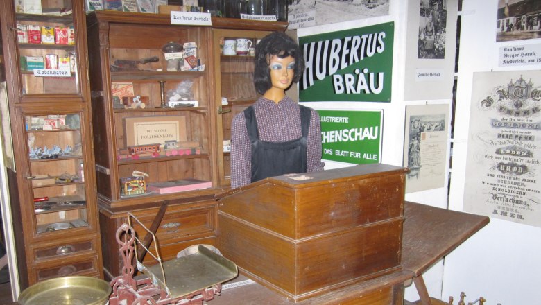 Historic store in the Niederleis local history museum with scales, mannequin and old advertising signs.