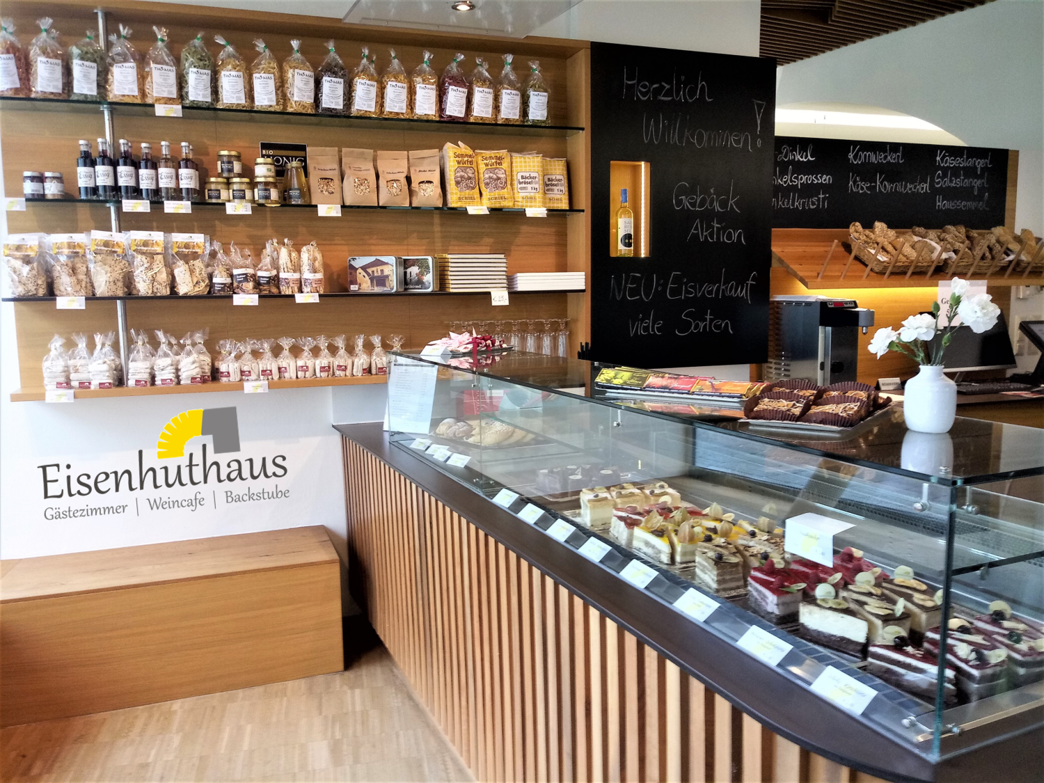 Interior view of a store in the Eisenhuthaus with pastries and cakes in a display case.