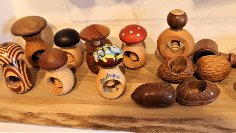 Various wooden nutcrackers in the shape of mushrooms on a shelf in the Nusseum Krummnußbaum.