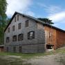 Neunkirchen house on the Flatzer Wand with wooden facade and blue sky.
