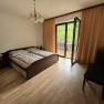 Bedroom with double bed, balcony and curtains.