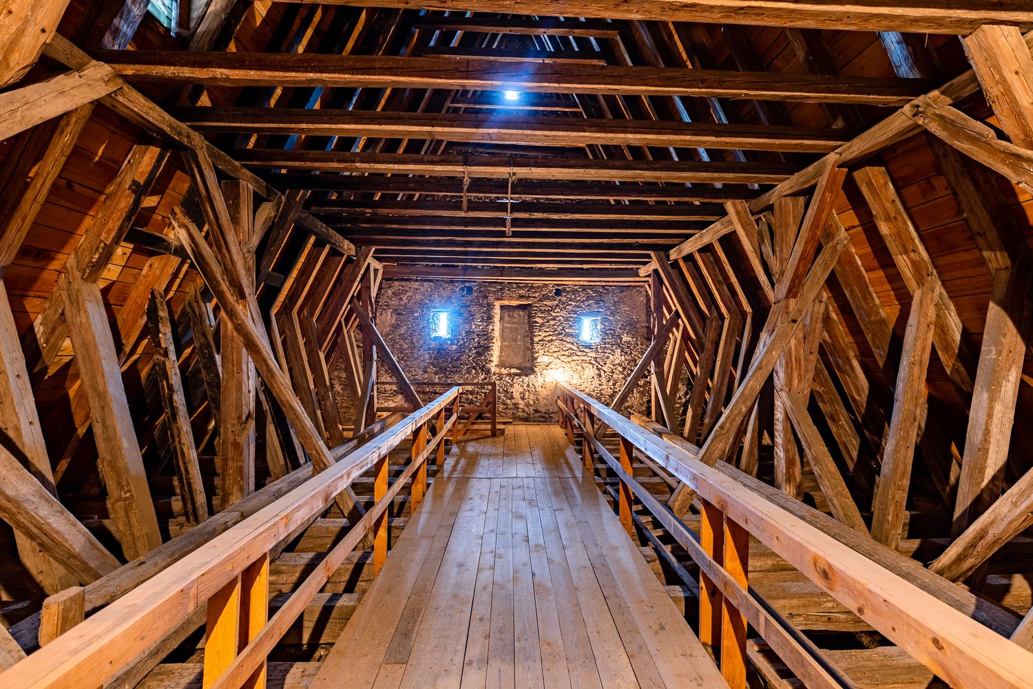 Interior view of the upper floor of the Lichtenegg fortified church with wooden beams and stone façade.