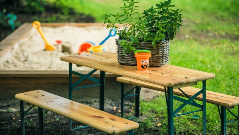 Children's pub set at the sandpit next to a green meadow