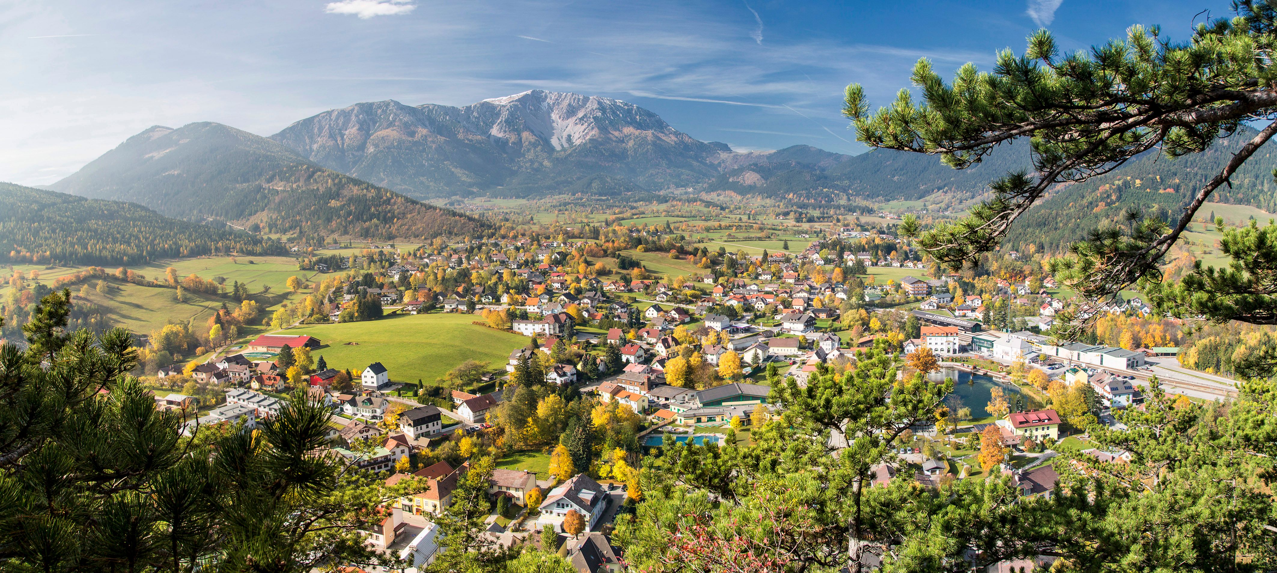 Panoramic view of Puchberg am Schneeberg with the surrounding mountains and autumnal landscape.