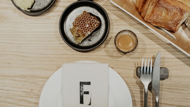 Breakfast pastries, honey, place setting