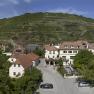 Panorama of a village with vineyards in the background.
