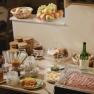 Breakfast buffet with bread, cold cuts, fruit and drinks.