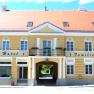 Yellow building with red roof and lettering 'Gasthof-Hotel Familie Klapka'.