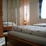One bedroom with wooden furniture, a double bed and a large closet with mirrors.