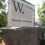 Wagner winery sign with vines in the background.