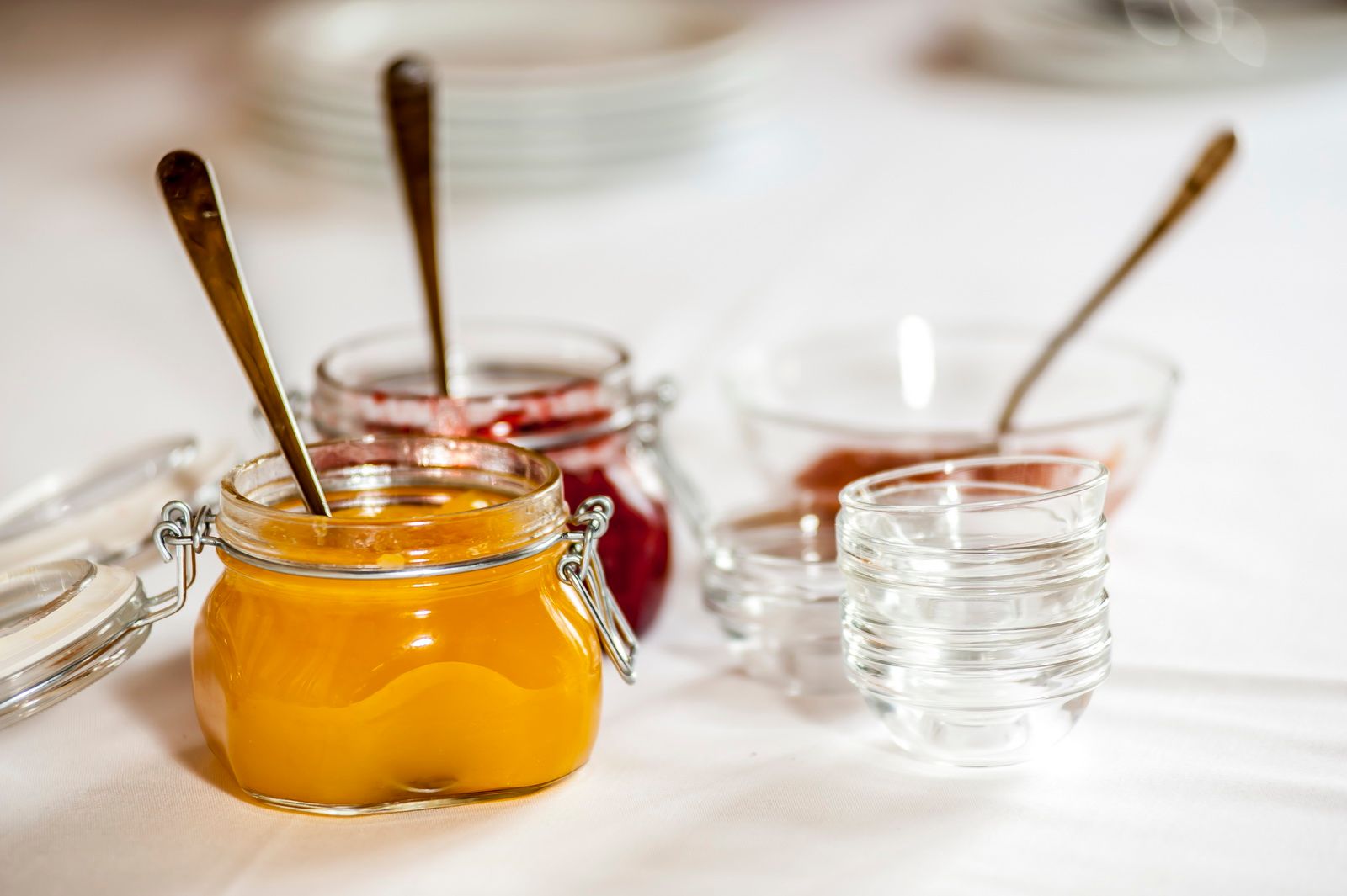 Close-up of jam jars on a table.