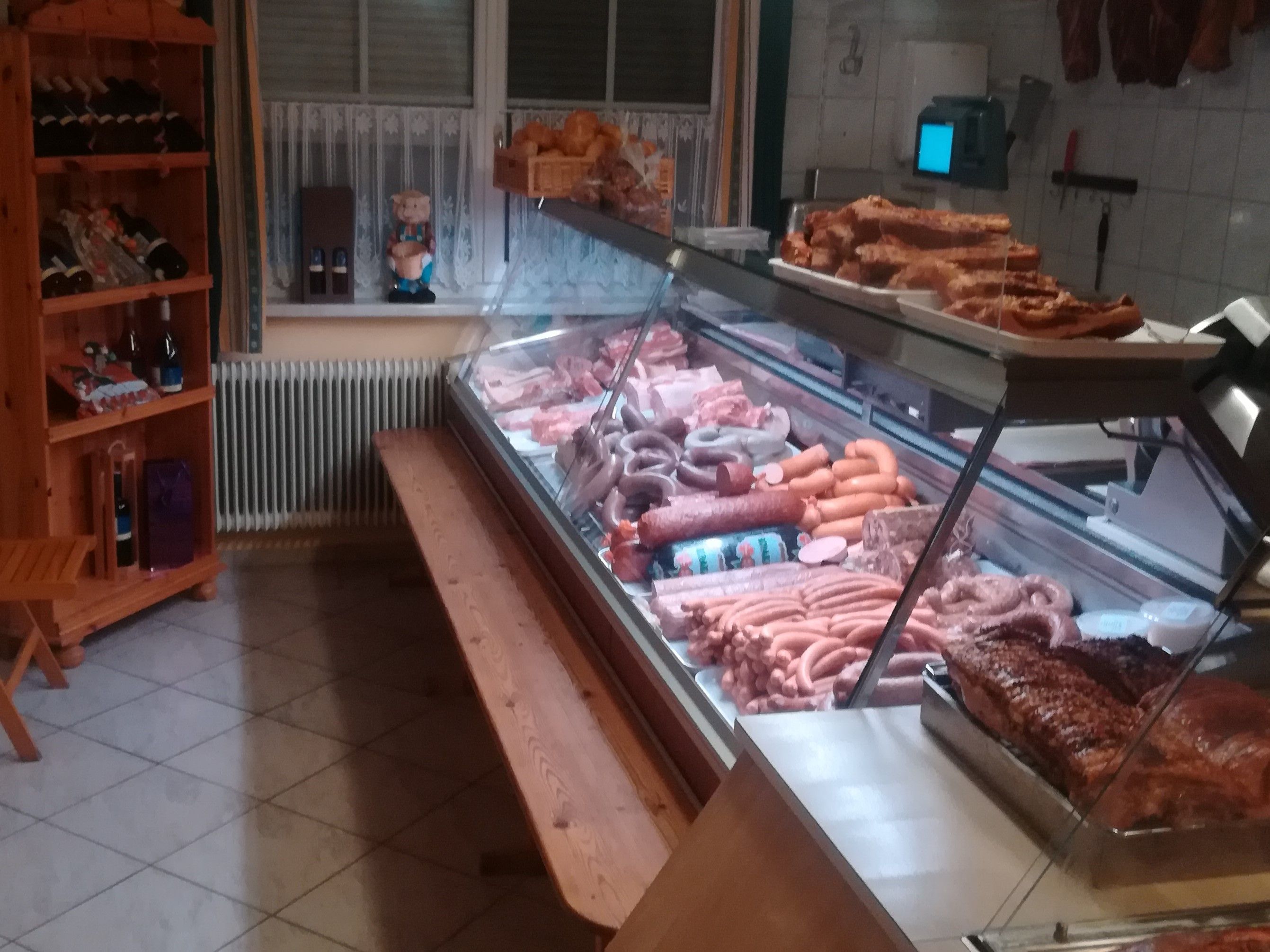 Butcher's shop with meat and sausage products in a sales counter.