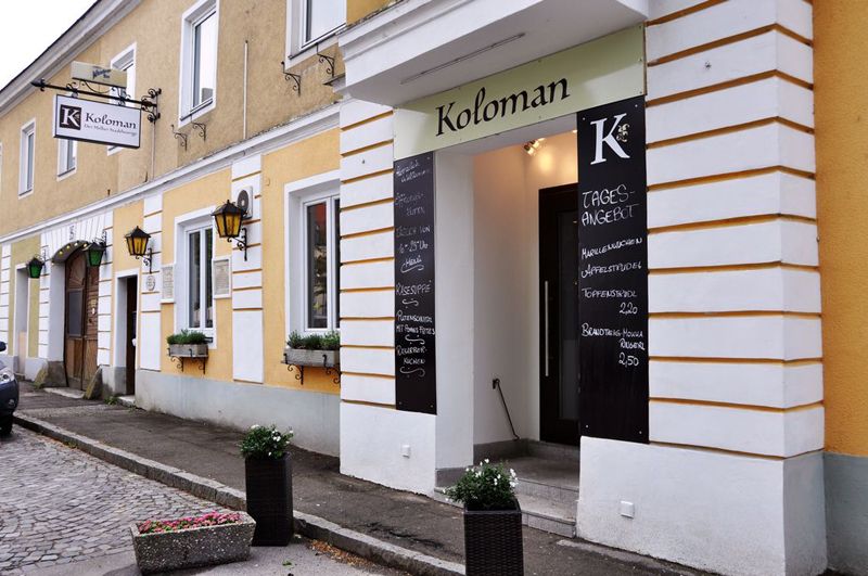 Entrance to Restaurant Koloman in Melk with daily specials on blackboards.