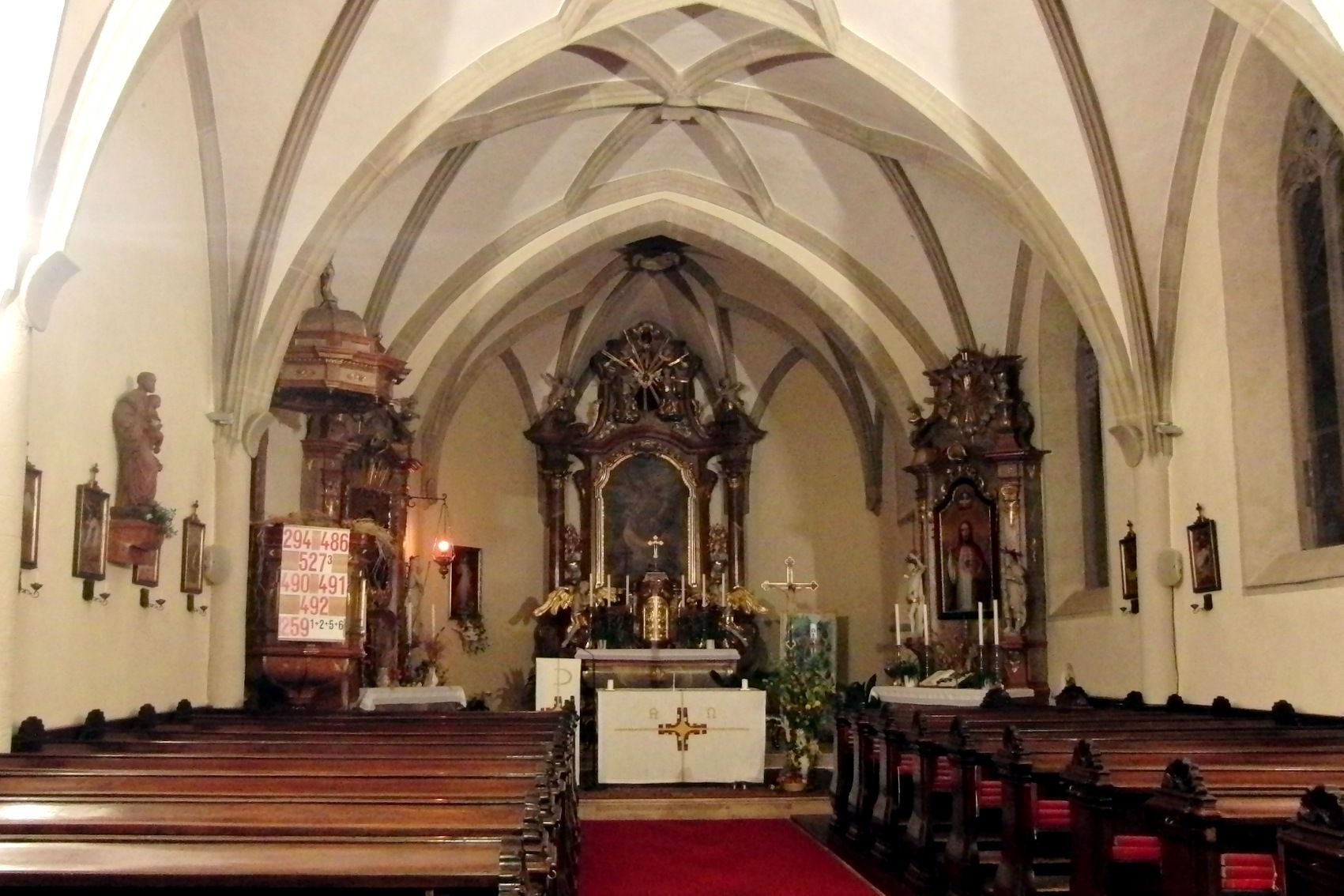Interior view of a church with altar and pews.