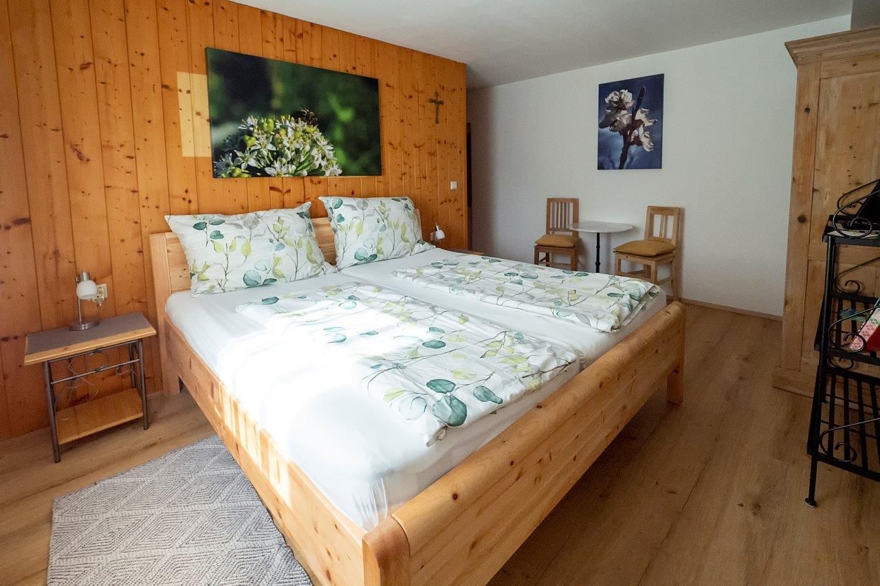 Cozy bedroom with wooden furniture and double bed.