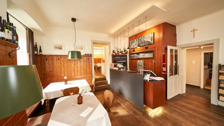 Interior view of a cozy dining room with wooden furniture and bar.