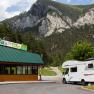 Motorhome in front of the Rax Park'n'Camp building with mountain backdrop.