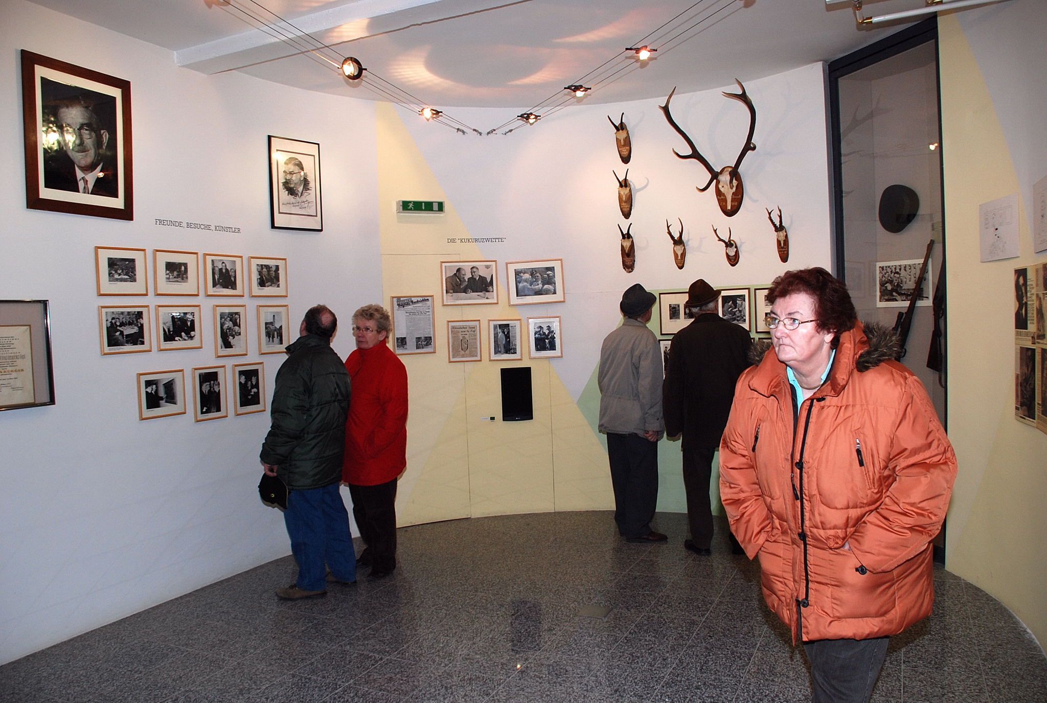 Visitors to the Leopold Figl Museum view photos and hunting trophies on the walls.