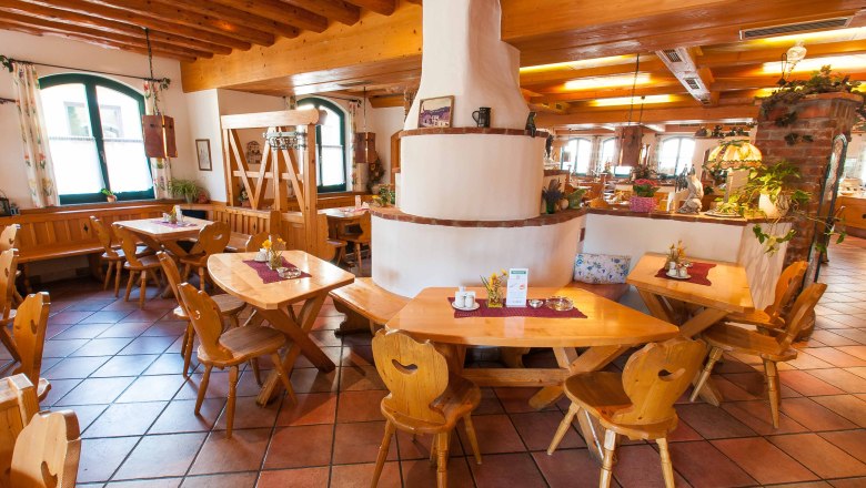 Cozy restaurant with wooden furniture and rustic decor.