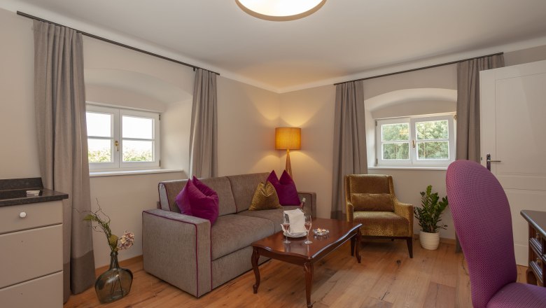 Elegant suite with sofa, armchair, table and decoration.