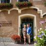 The Wildeis family stands in front of a historic building with flowers and the inscription 'Kirchenwirt Restaurant Wachau'.