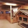 Interior view of a wooden goat pen with goat enclosure and small house.