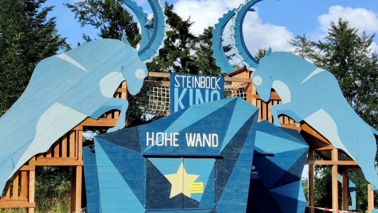 Entrance to the Steinbock Cinema in the Hohe Wand Nature Park with blue ibex silhouettes.