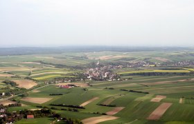 Aerial view of Hochleithen, surrounded by fields and forests.
