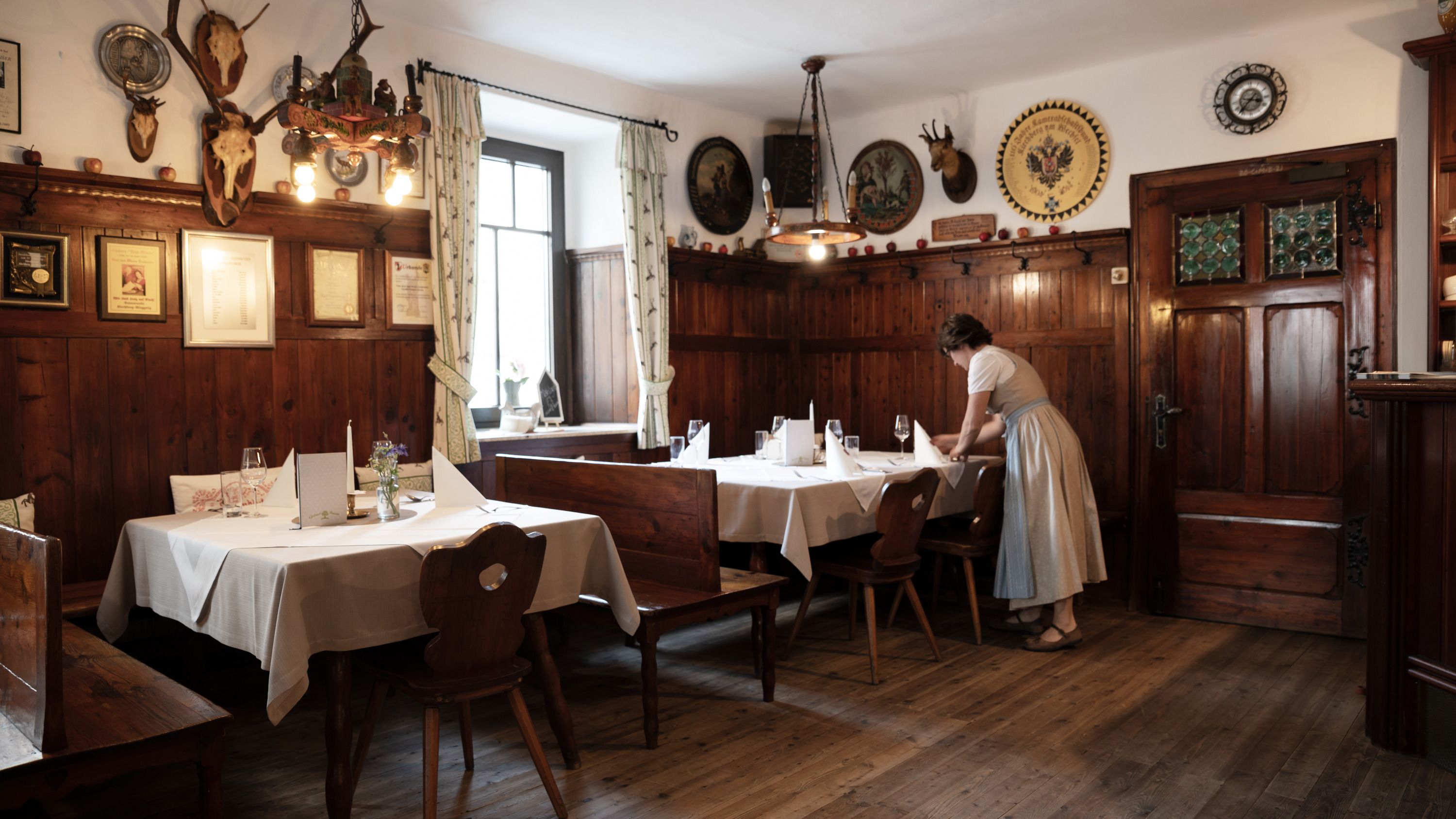 Traditional inn with wood paneling and hunting trophies on the walls.