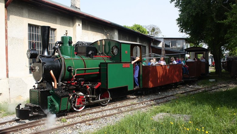 Steam locomotive with passenger carriages in the Schwechat Railway Museum.