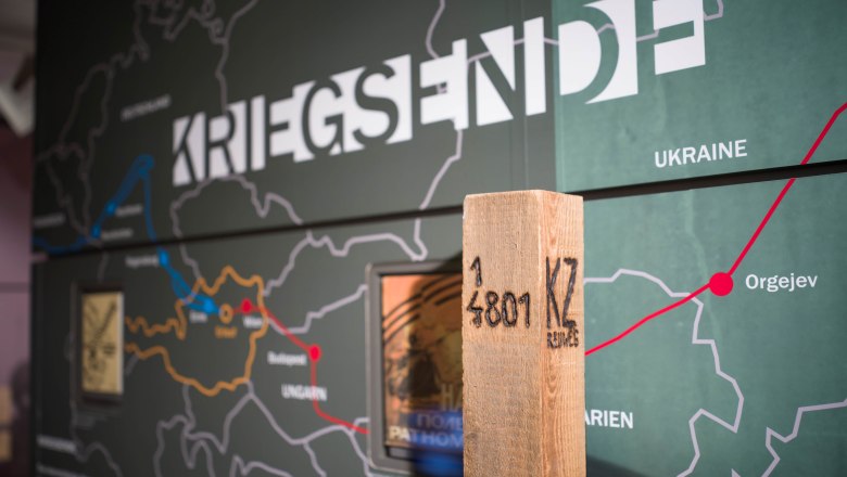 Interior view of the Erlauf Peace Museum with a map and a wooden post.