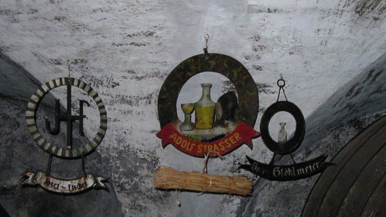 Three old tavern signs on a wall in the local history museum.