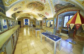 Interior view of the treasury of Maria Taferl Basilica with decorated ceilings and display cases.