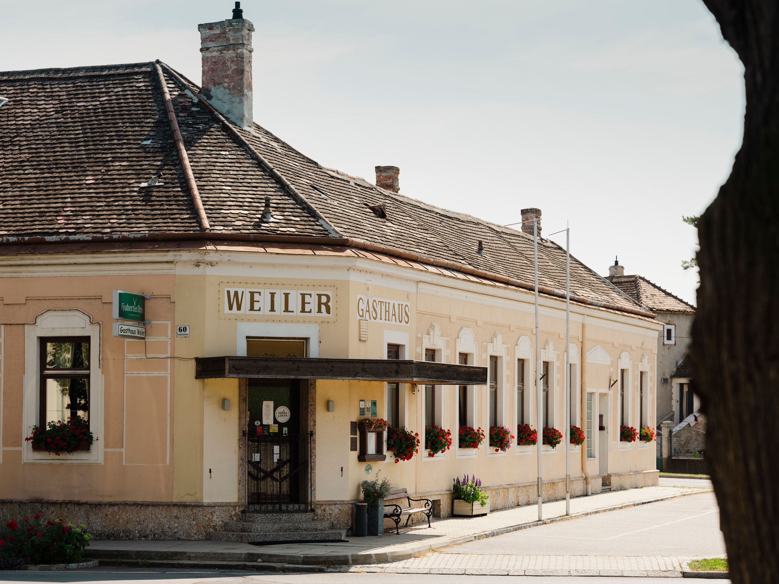 Historic Weiler inn in Laa an der Thaya with flower-decorated windows.