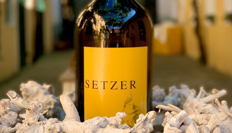 Magnum bottle of Setzer wine in a decorative setting with pieces of wood.