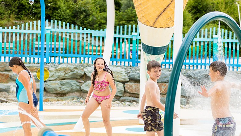 Children play in the outdoor water park.