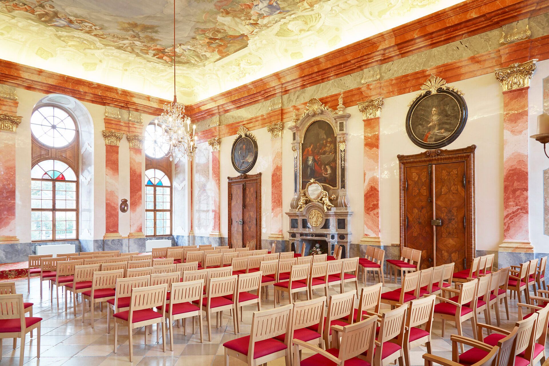 Interior view of a magnificent baroque hall with stucco ceiling and chandelier in Geras Abbey.