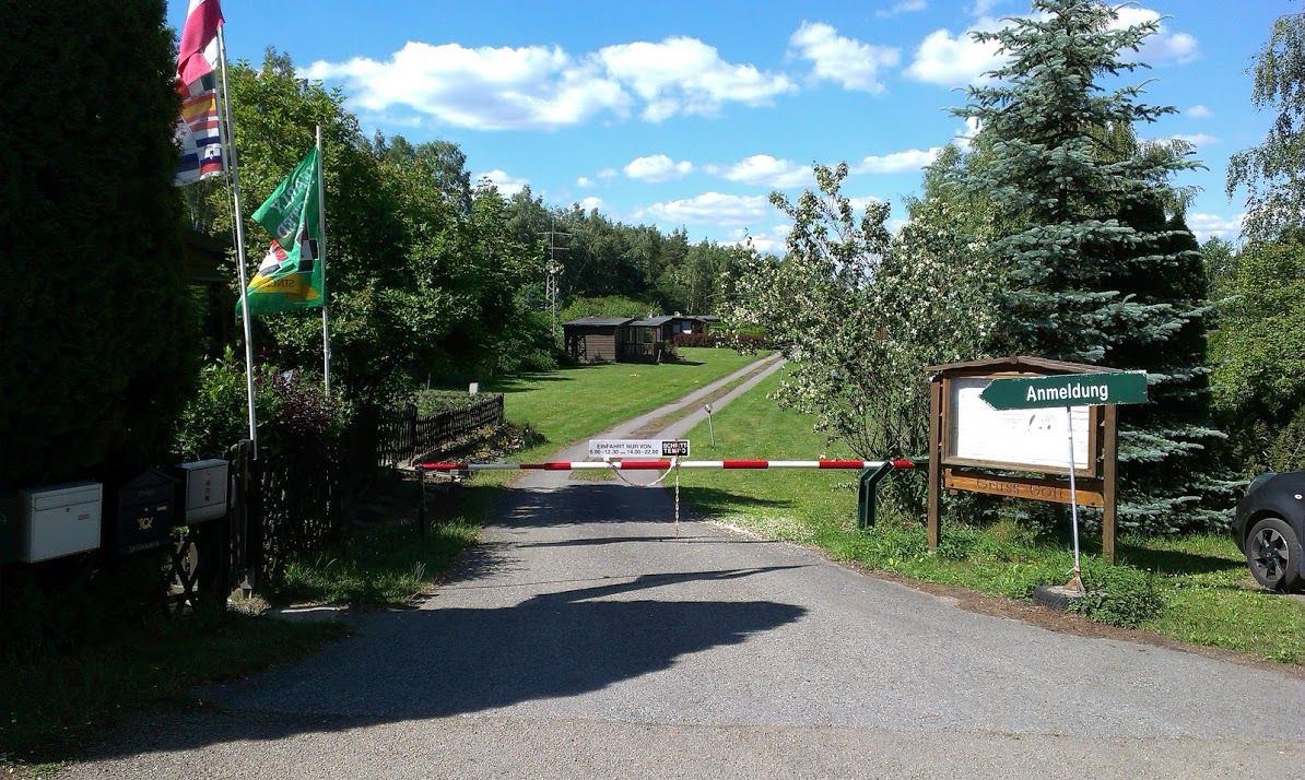 Entrance to a campsite with barrier and registration sign.