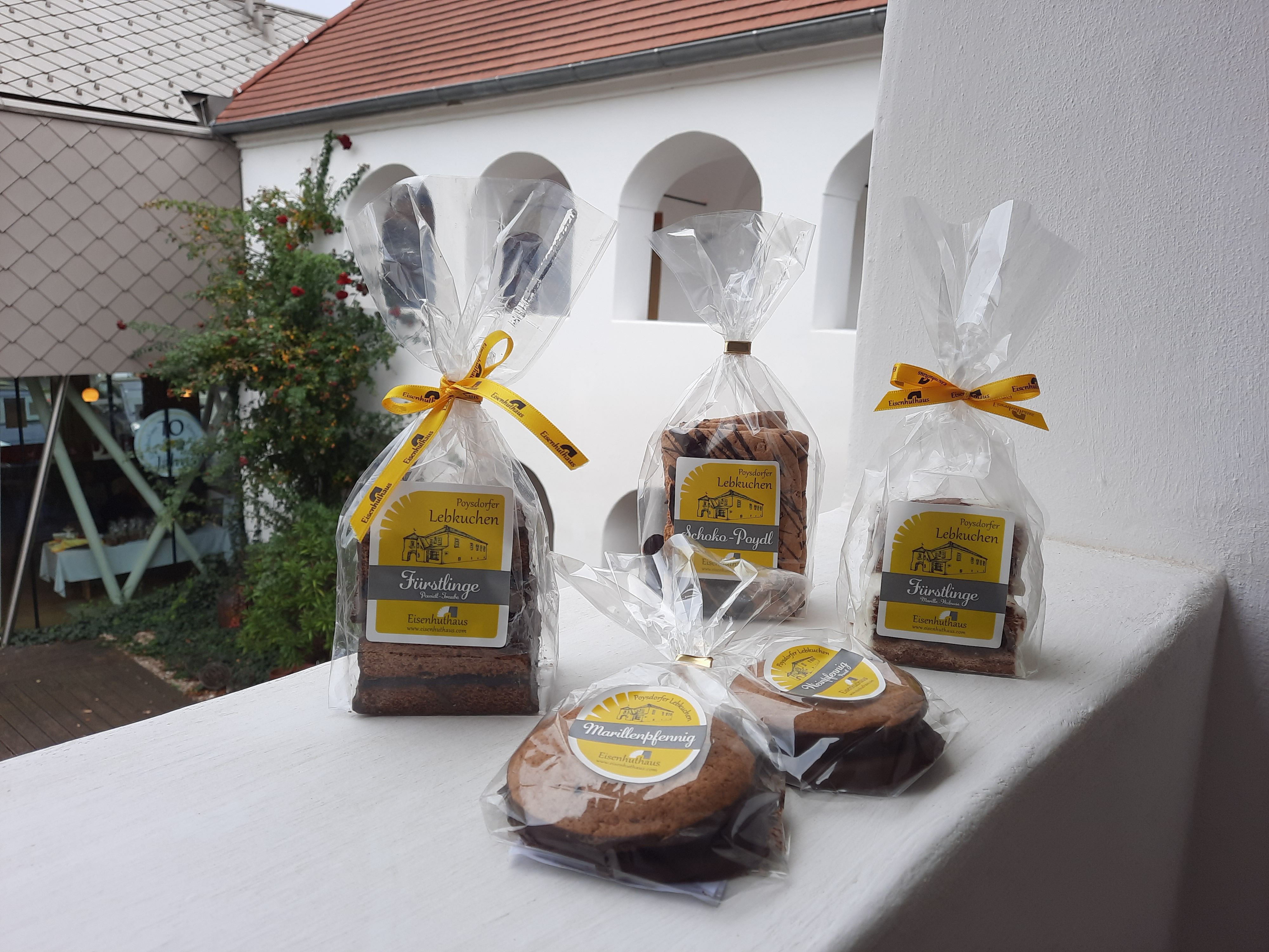Packed gingerbread in the foreground, white arcaded courtyard in the background.