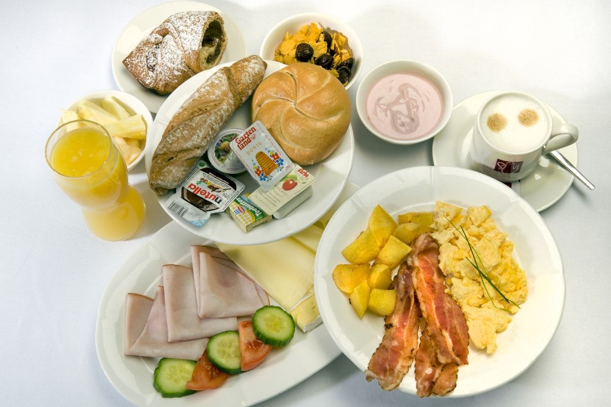 Various dishes from the breakfast buffet served on plates.