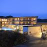 Hotel Molzbachhof at night with illuminated windows and pool.
