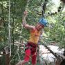 Child with helmet in the climbing park on a rope course.
