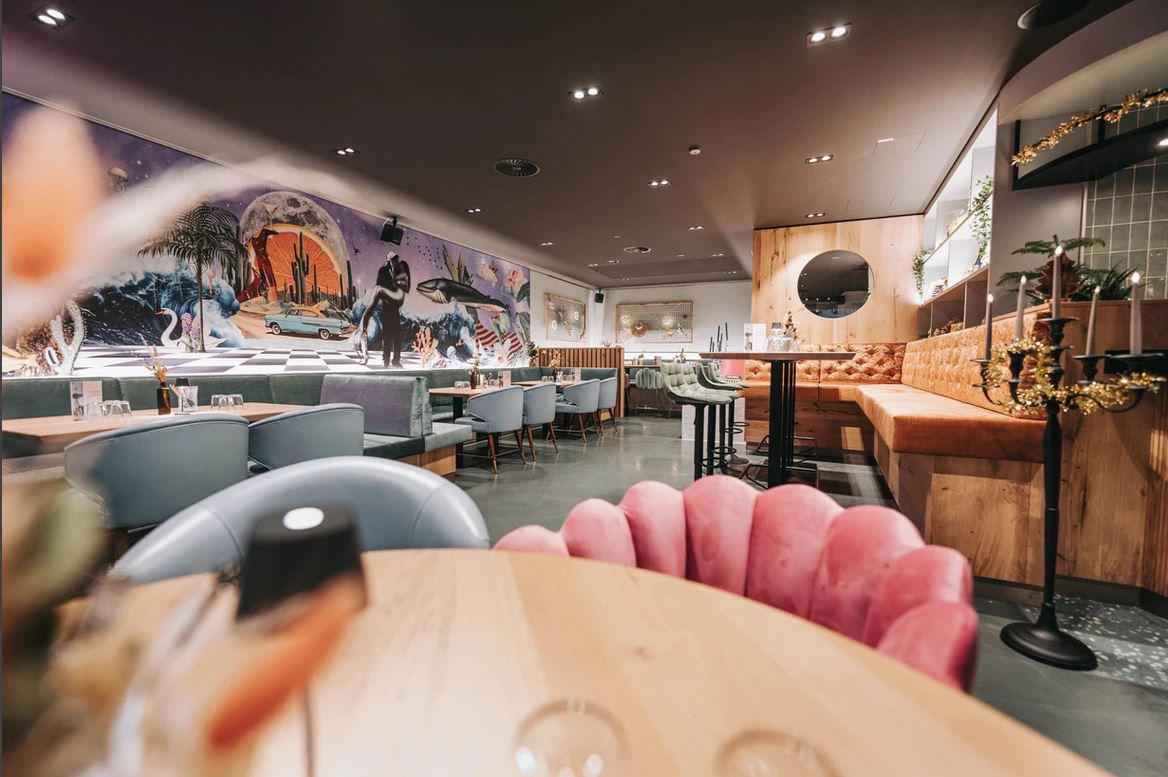 Interior view of a stylish restaurant with modern furnishings and wall art.