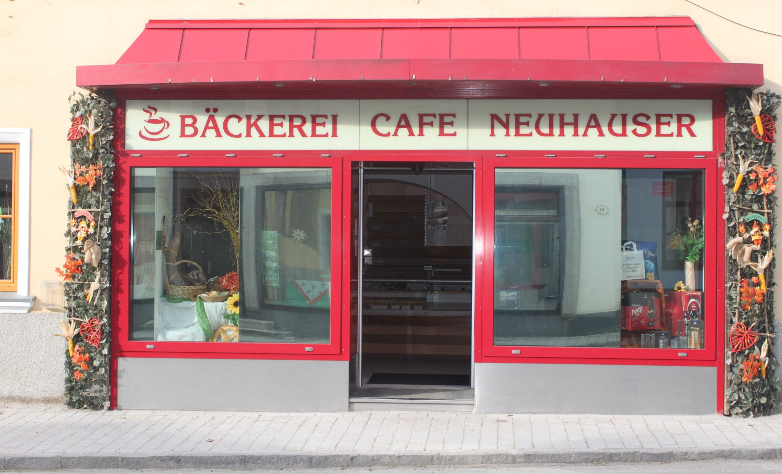 Entrance of a café with red frame and decoration.