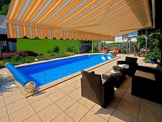 Terrace with pool and awning at vacation home Eva Deufl.