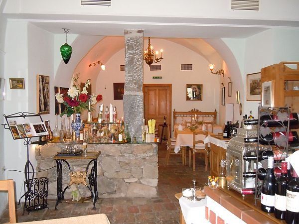 Interior view of a cozy restaurant with rustic decoration and laid tables.